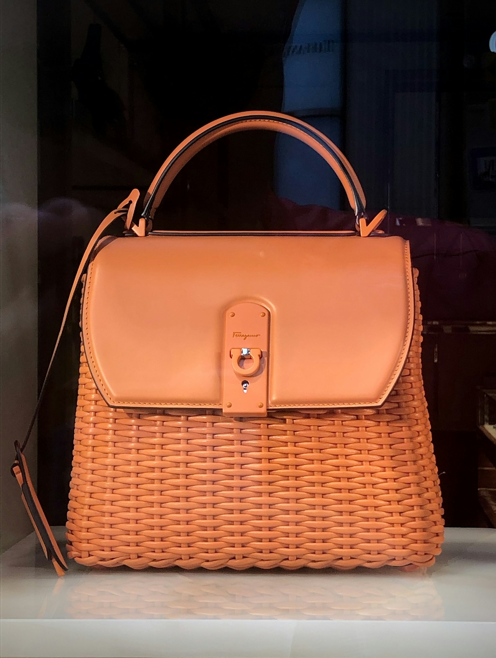 Elegant woman carrying structured designer leather tote bag